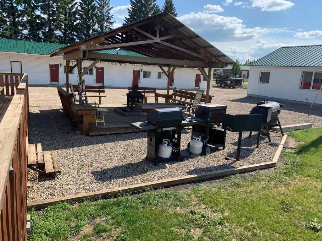a pavilion with a picnic table and a grill at Gateway Motel in Minnedosa