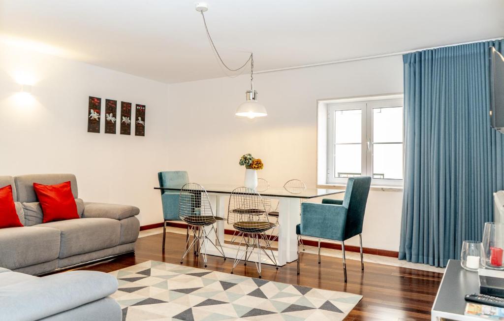 a living room with a couch and a table and chairs at Chiado Patio Apartment in Lisbon