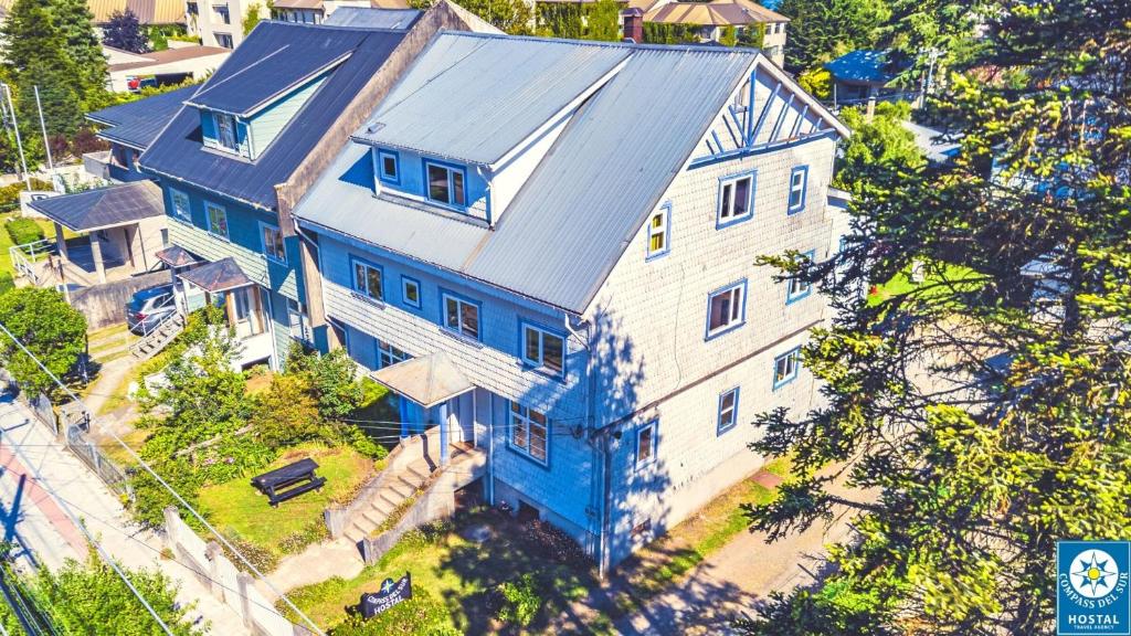 an overhead view of a large blue and white house at Hostal Compass del Sur in Puerto Varas