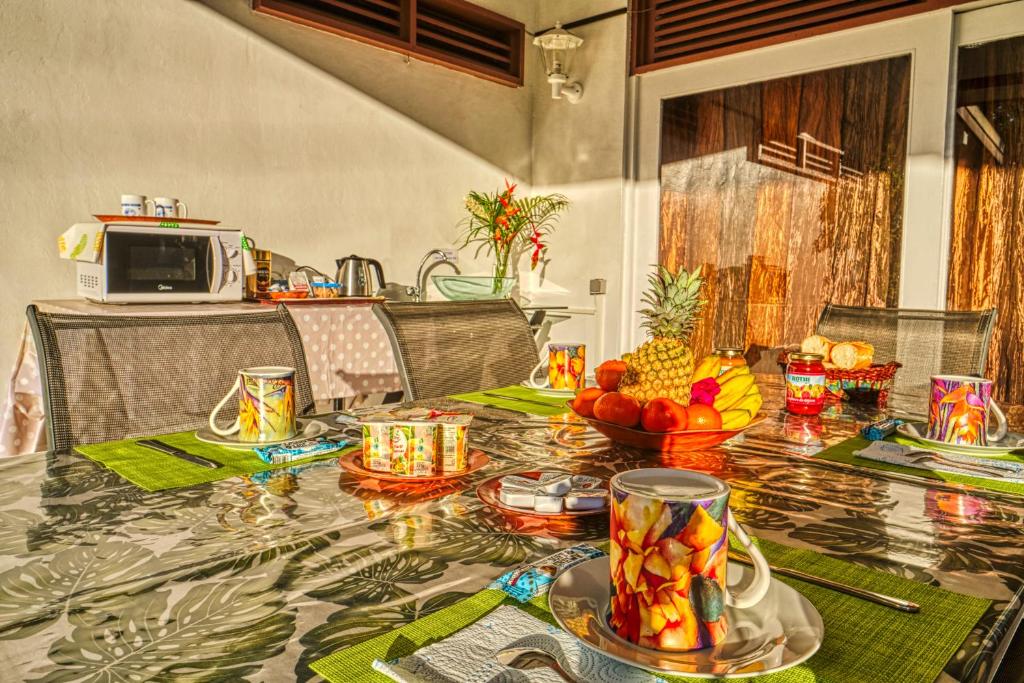 a table with fruit on it in a kitchen at Inaiti Lodge in Papeete