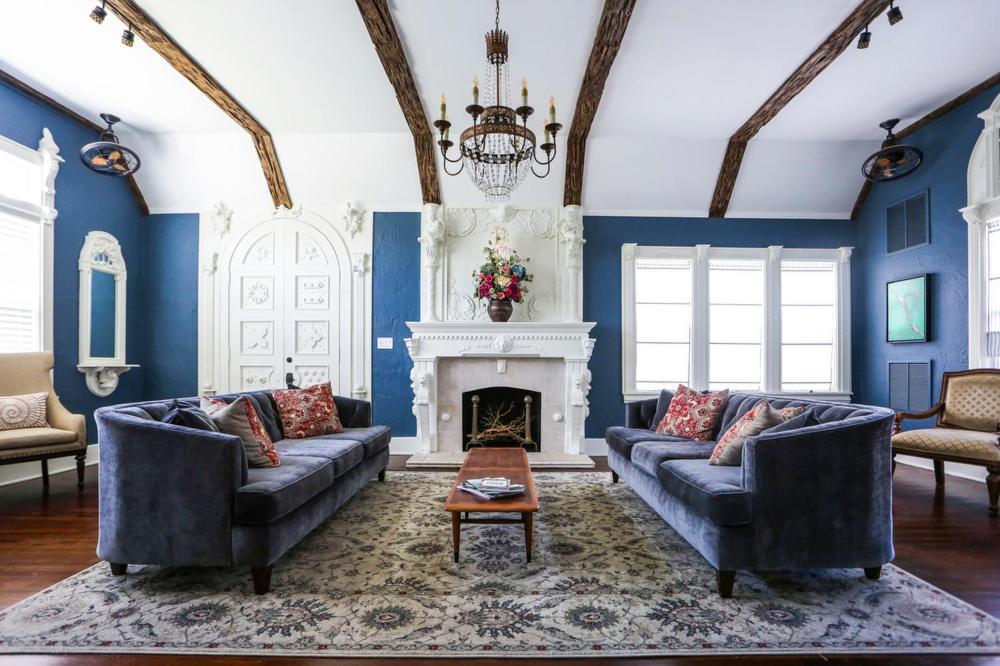 a blue living room with two couches and a fireplace at The Kenwood Gables in St. Petersburg