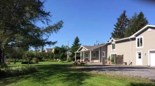 a house with a picnic table in the yard at Gite Duchenier in Saint-Narcisse-de-Rimouski
