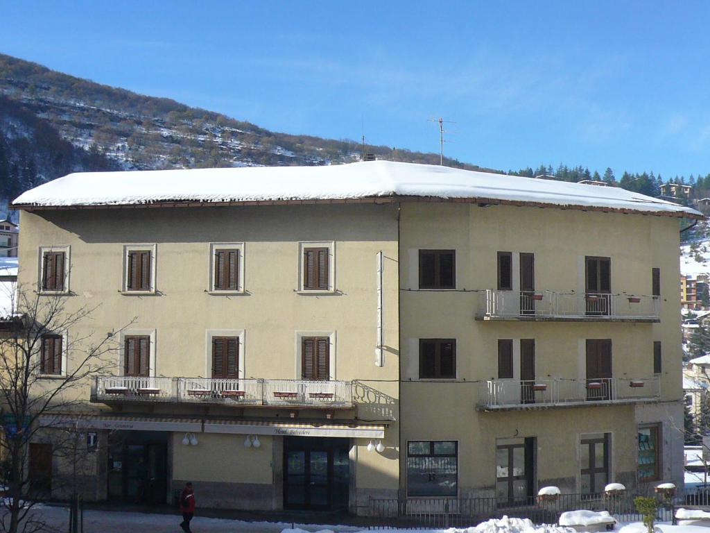 a large building with snow on the top of it at Albergo Belvedere in Scanno