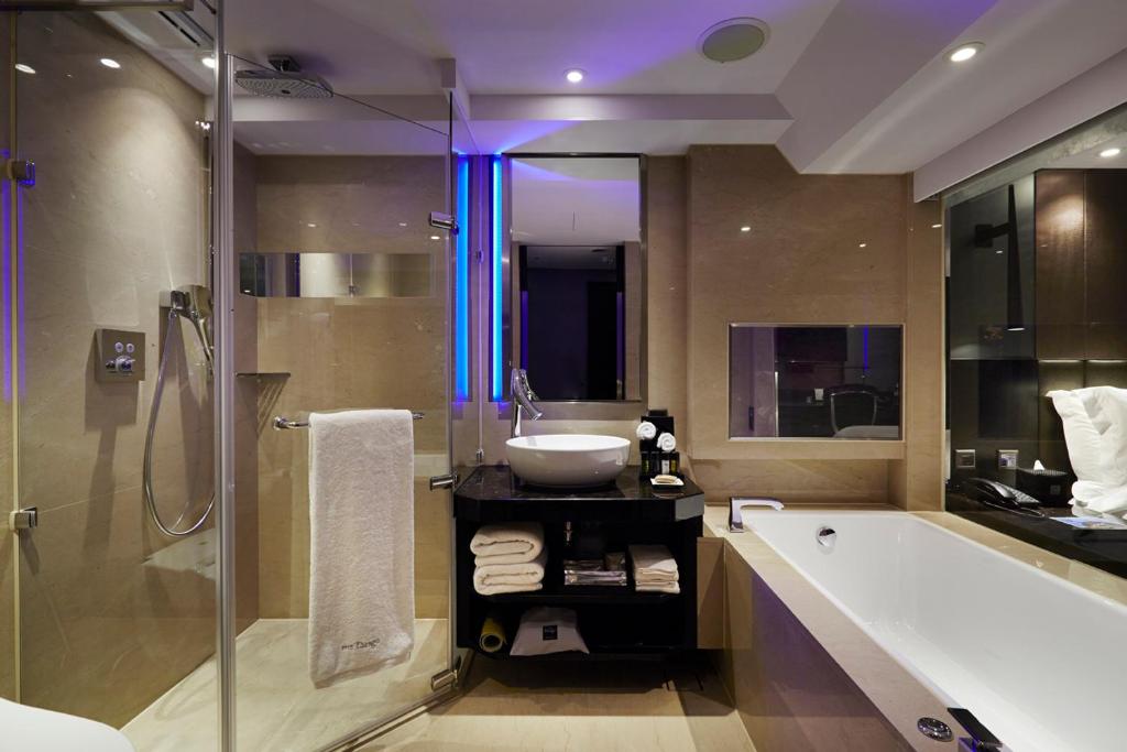 a bathroom with a tub and a sink and a shower at The Tango Hotel Taipei FuHsing in Taipei