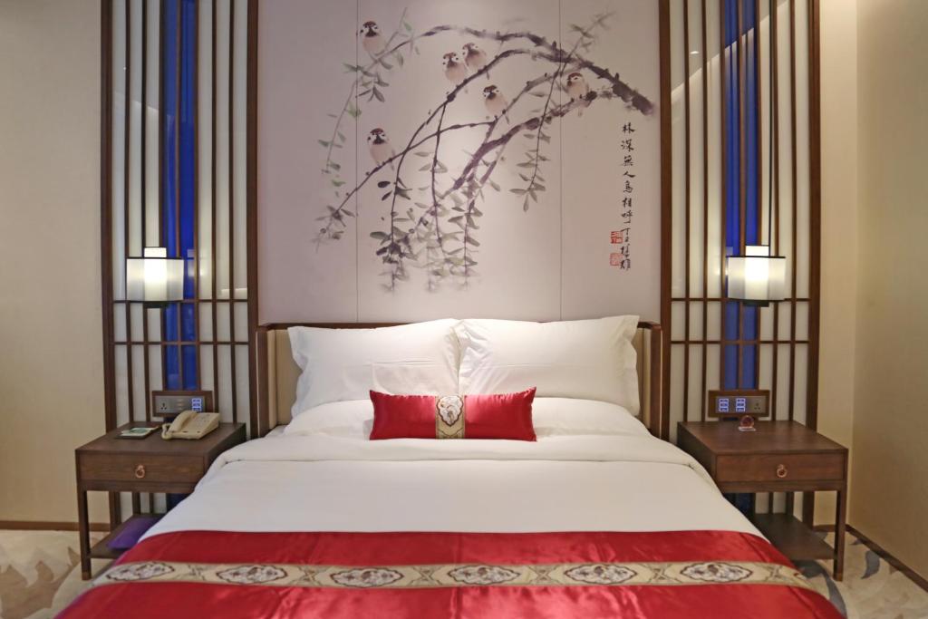 Postel nebo postele na pokoji v ubytování Guangdong Yingbin Hotel-Free Canton Fair Shuttle Bus