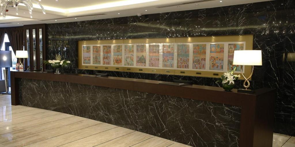 a lobby with a black marble wall with signs on it at Crowne Plaza Istanbul Oryapark by IHG in Istanbul