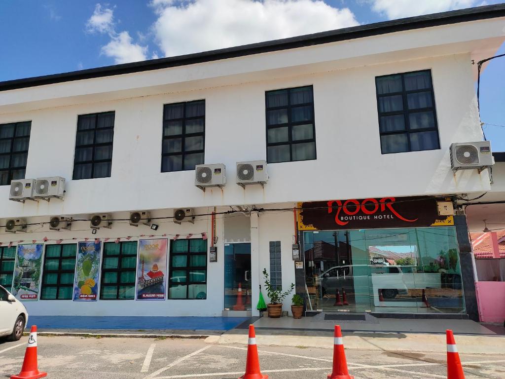 un bâtiment avec des cônes orange devant lui dans l'établissement Noor Boutique Hotel, à Kuala Perlis