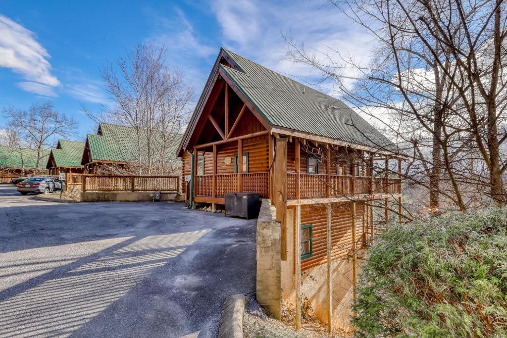 a large wooden cabin with a gambrel roof at Vista Point in Pigeon Forge