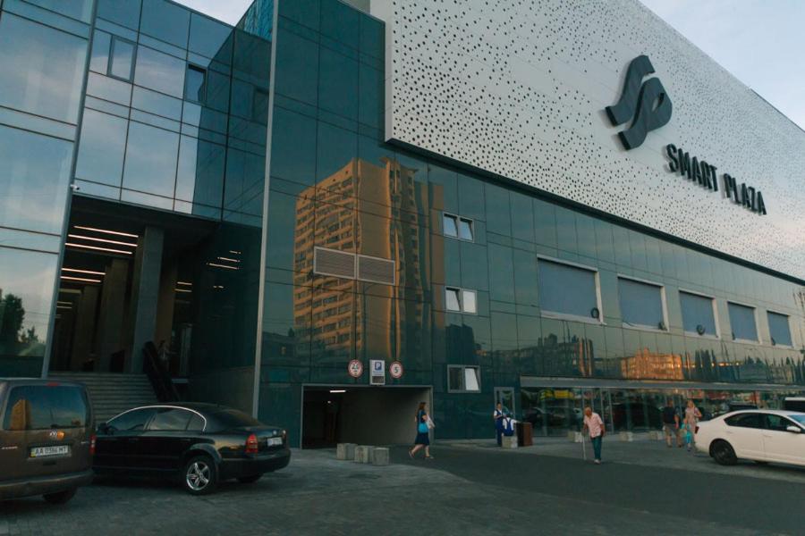 a building with cars parked in front of it at Apart Plaza 24 in Kyiv
