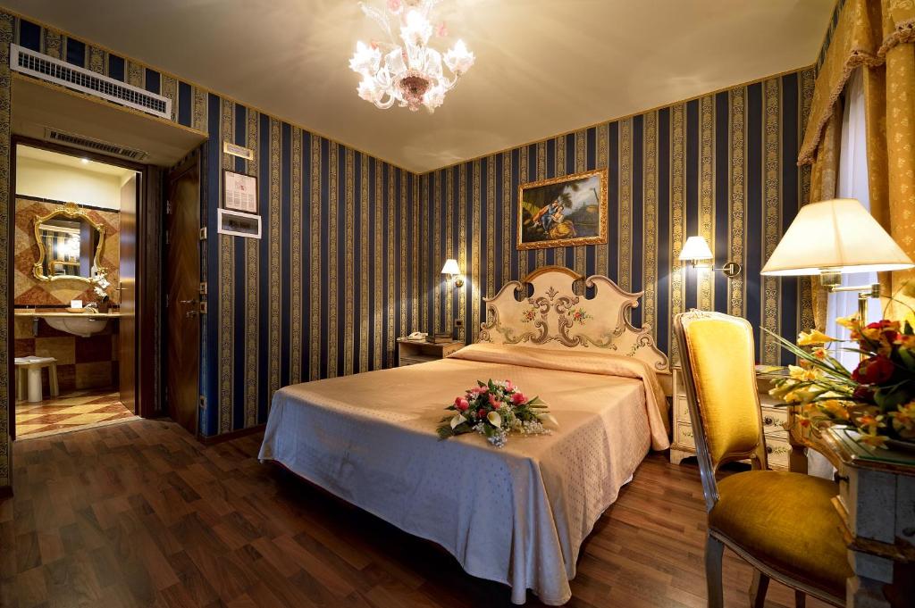 a bedroom with a bed with flowers on it at Antico Panada in Venice