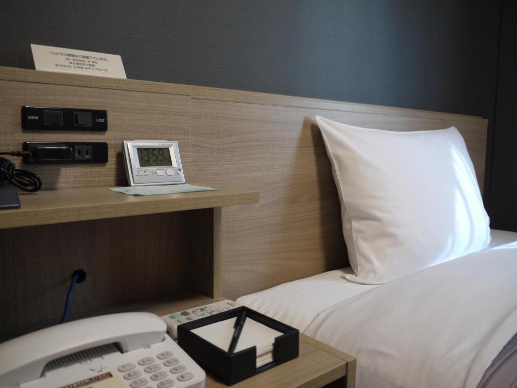 Postel nebo postele na pokoji v ubytování Hotel Route-Inn Shinfujieki Minami