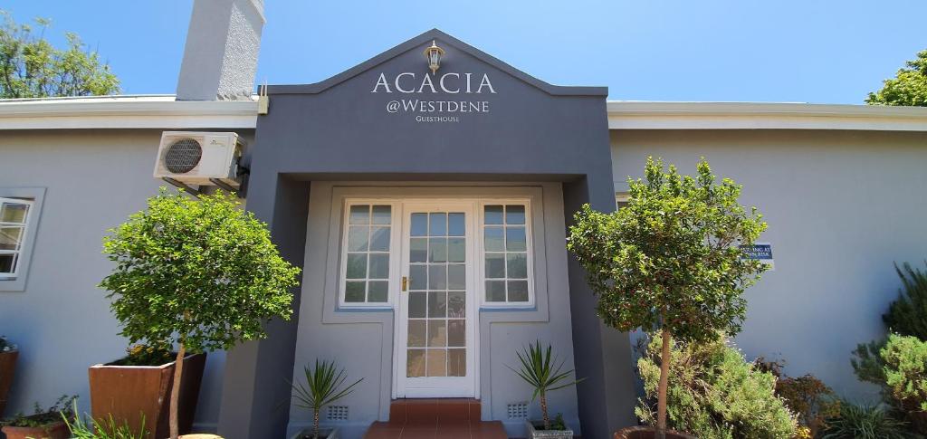 a white house with a sign that reads acadia christmas at Acacia Westdene B&B in Bloemfontein