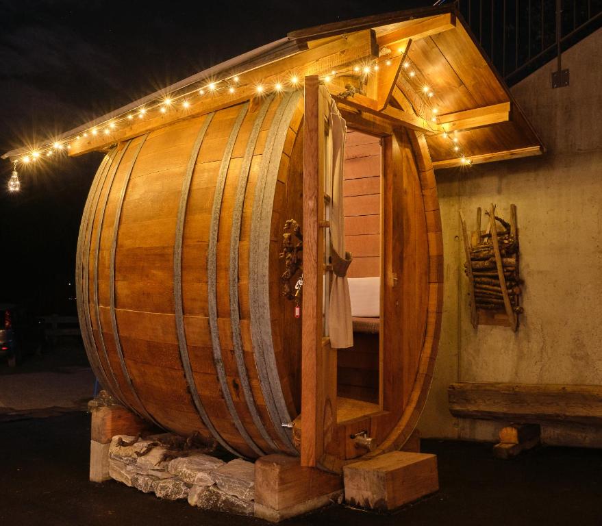 a large wooden barrel with lights on top of it at Chalet Diognysos B&B, Boutique Hotel & Wellness in Crans-Montana
