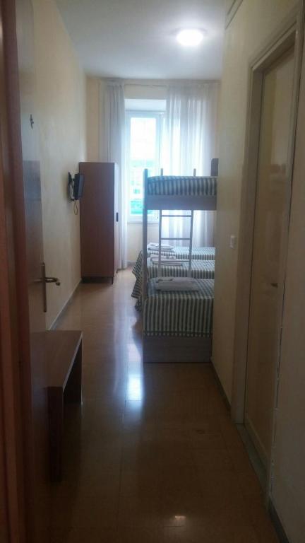 a living room with a crib and a window at Ostello Villa Monte Mario in Rome