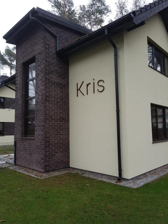 a white building with the word kris written on it at Villa Kris in Pobierowo