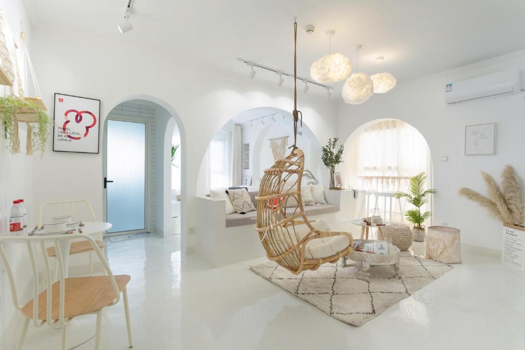 a white living room with a hanging chair at Wuhan City Wuchang District shahu park in Hankou