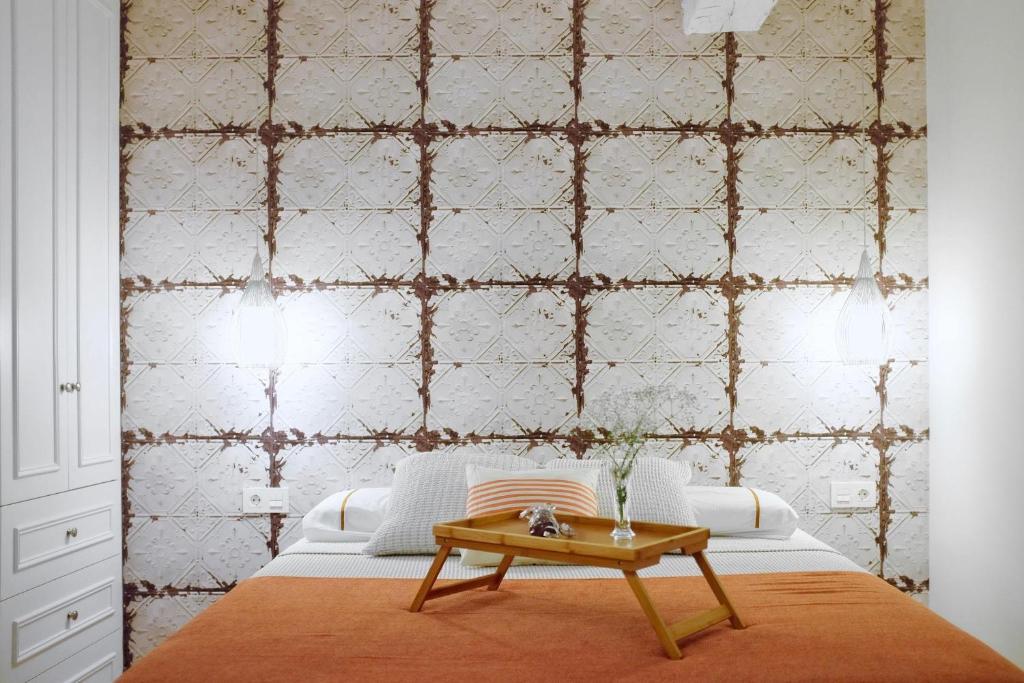 a bedroom with a bed with a table in front of a wall at Apartment Alaitz Rentería in Rentería