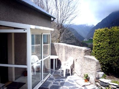 a house with a patio with a view of the mountains at BOYRIE Daniel et Hélène in Gavarnie