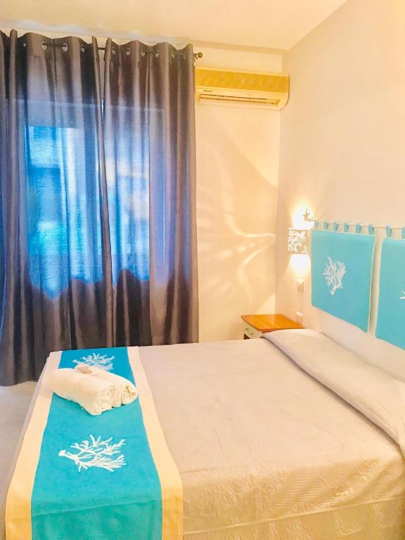 Postel nebo postele na pokoji v ubytování Hotel Sandalion