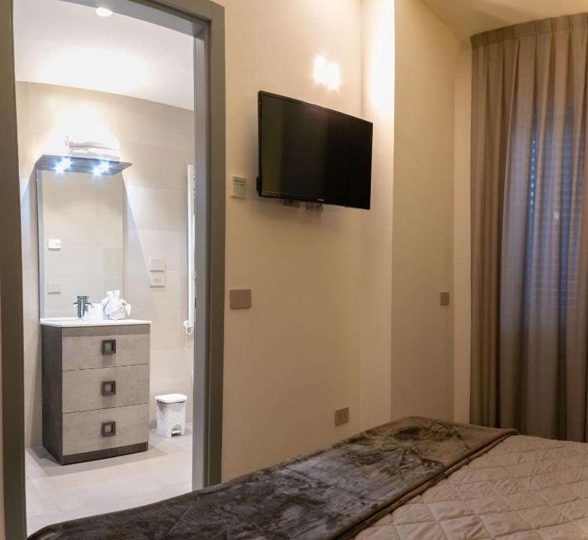 Postel nebo postele na pokoji v ubytování BRIGANTE SUITES