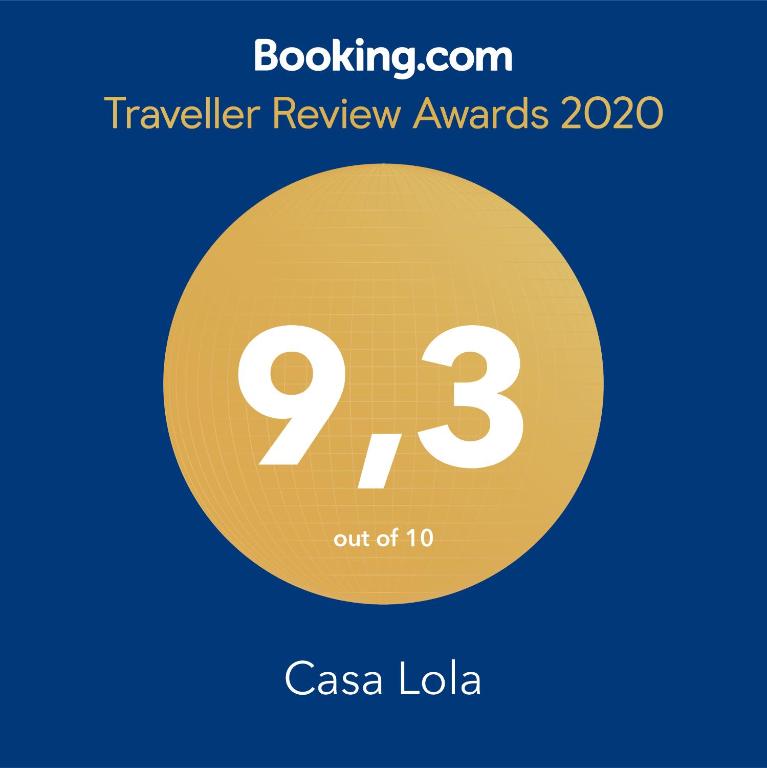 a yellow circle with the number nine and the text travelling review awards at Casa Lola in Agaete