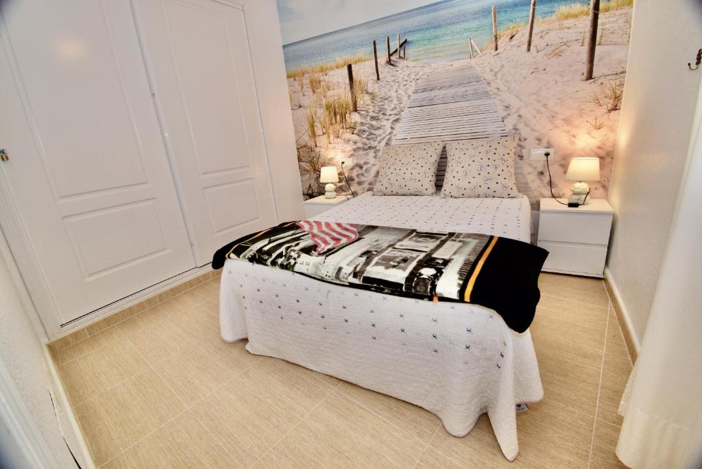 two beds in a room with a beach mural at 027 La Mata View Natural Park in La Mata