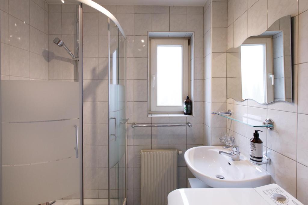 a bathroom with a shower and a sink at Dimai House No 15 Dornbirn Zentrum in Dornbirn