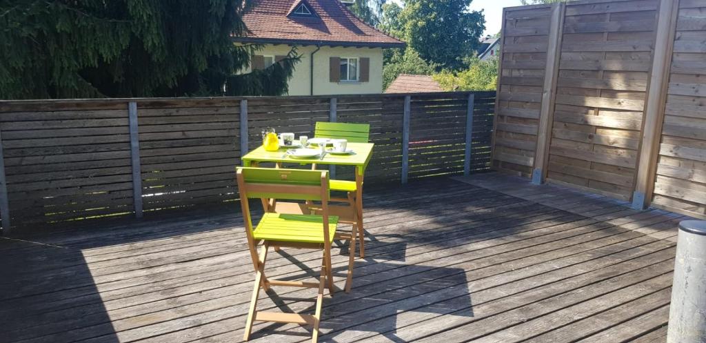 a yellow and green table and chairs on a deck at Dimai House No 15 Dornbirn Zentrum in Dornbirn