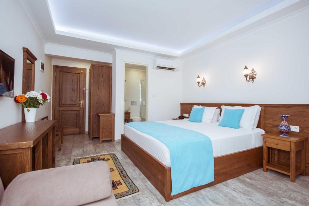 a hotel room with a bed and a couch at Infinity City Hotel in Fethiye