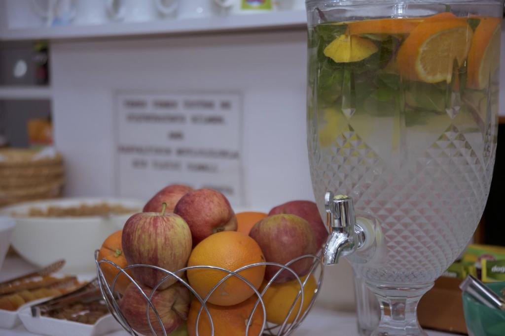 a bowl of fruit sitting next to a blender at Infinity City Hotel in Fethiye