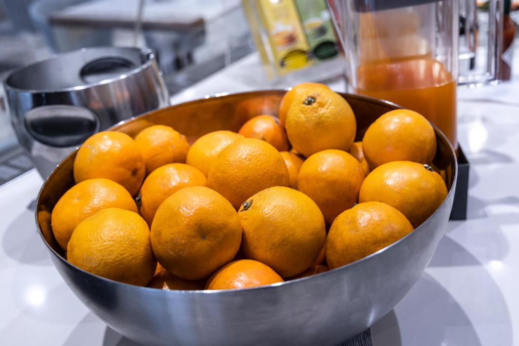 a metal bowl filled with oranges on top of a counter at Park Hotel Imperial in Limone sul Garda