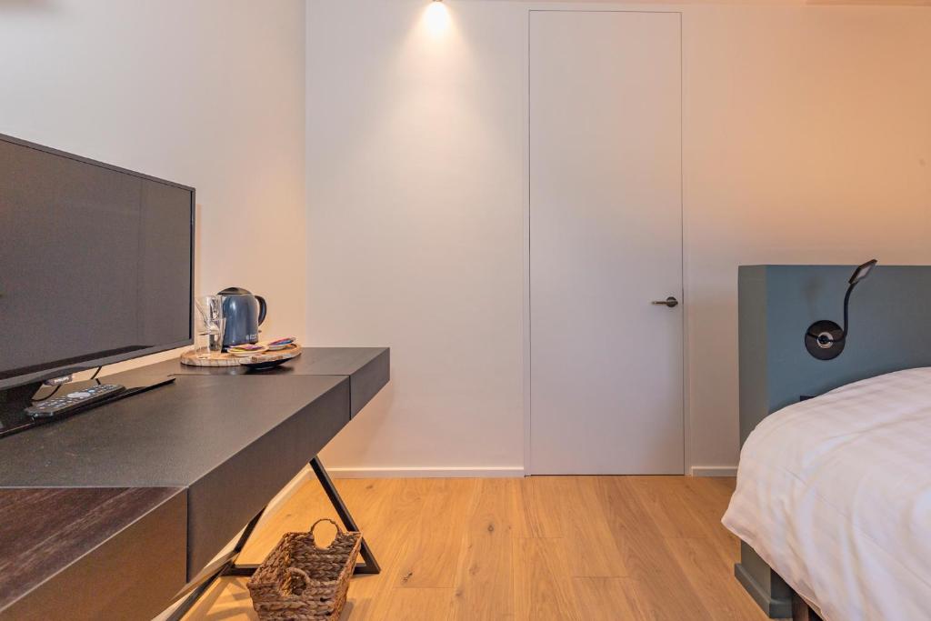 Postel nebo postele na pokoji v ubytování Hotel De Jachthoorn