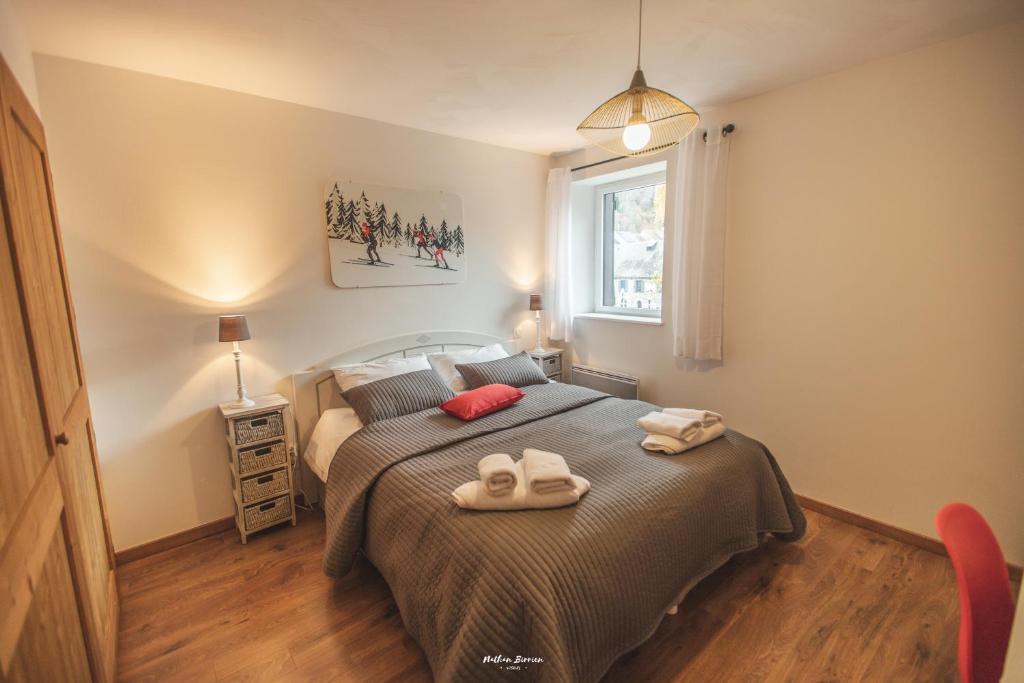 een slaapkamer met een bed met twee handdoeken erop bij L'appart de Lary in Saint-Lary-Soulan