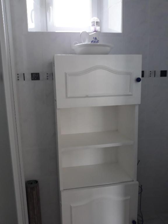 a white bathroom with a sink and a mirror at Chambres d'Hotes Elvire et Laurent Barbey in Sainte-Marie-du-Mont