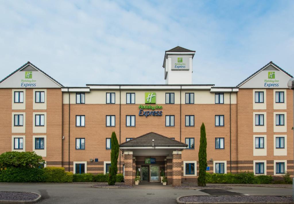 a large brick building with a clock tower on top at Holiday Inn Express London - Dartford, an IHG Hotel in Dartford