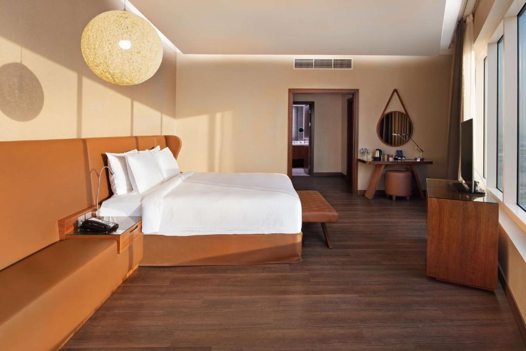 A bed or beds in a room at Radisson Blu Hotel, Dubai Canal View