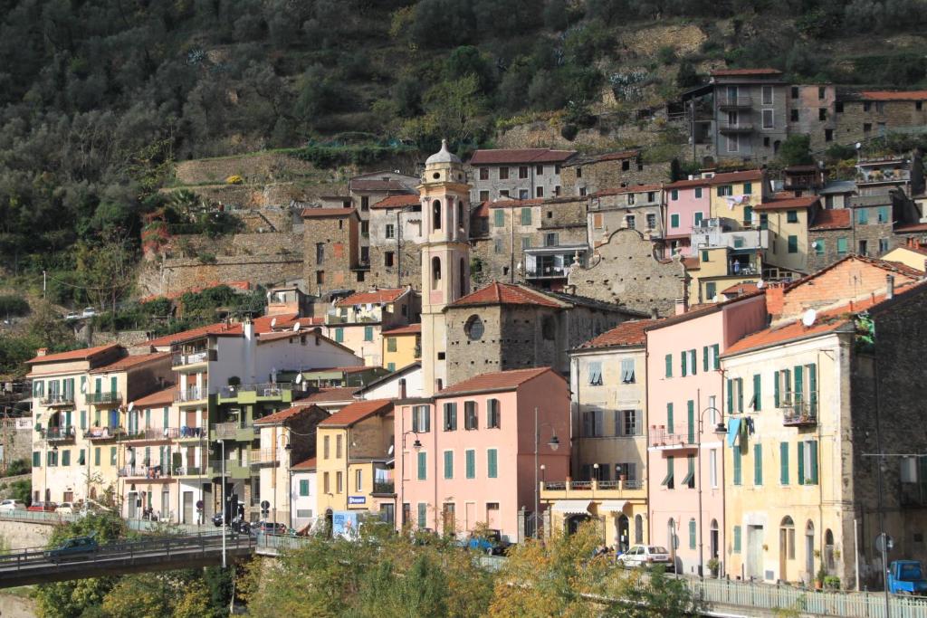 a group of buildings on a hill with a town at LA CASA BLU DI VEZZARGO in Badalucco