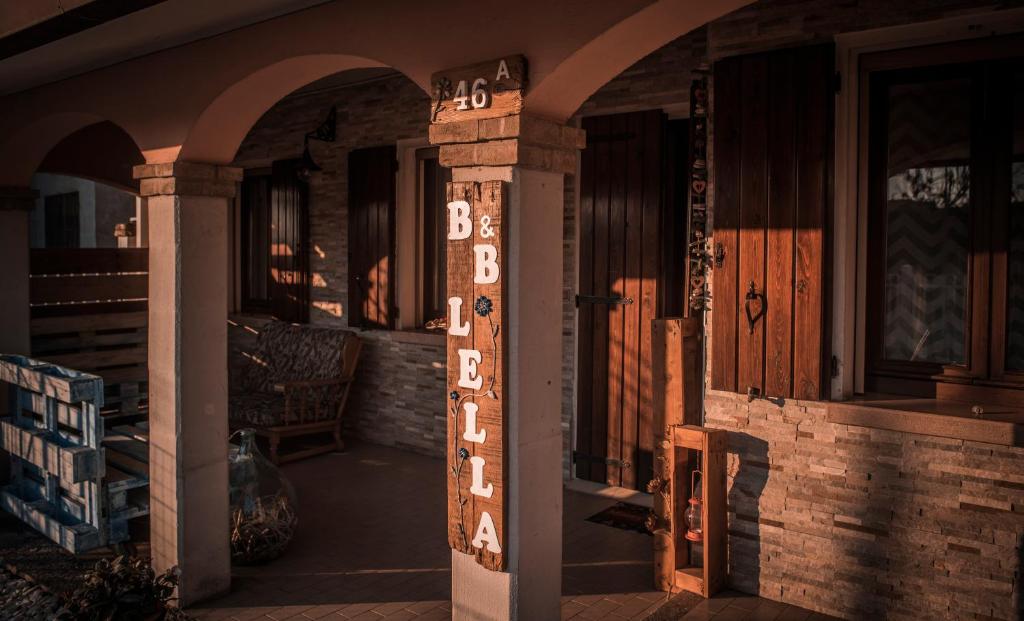 a porch of a house with a sign that says bbqs at B&B LELLA in Piove di Sacco