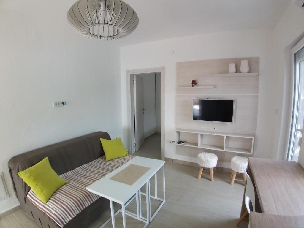 a living room with a couch and a table at Apartman Dajoda 1 in Bijela