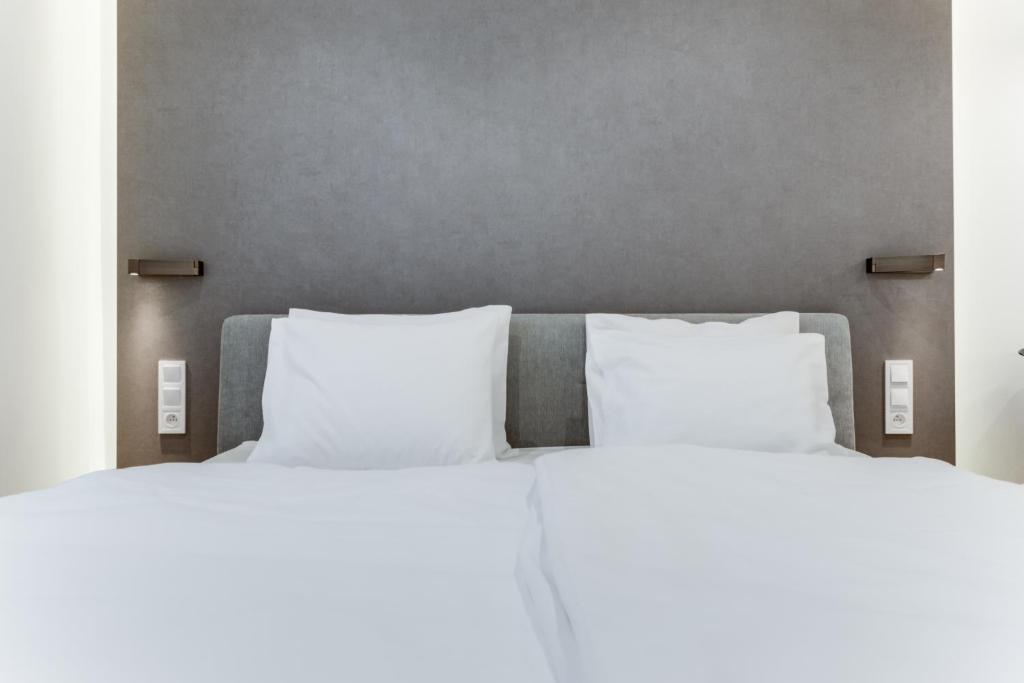 Postel nebo postele na pokoji v ubytování Lampi Aparthotel Prague