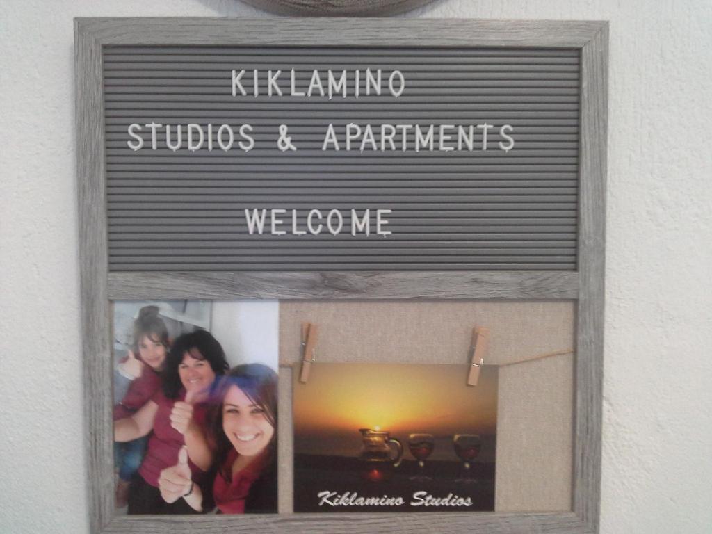 a sign for a photography studio andarrements website at Kiklamino Sunset Studios in Oia