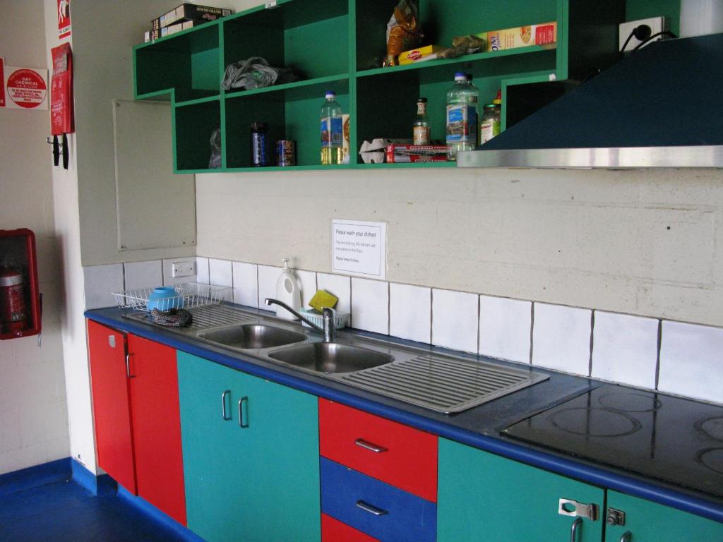 
a kitchen with a sink and a counter top at Beach Hostel Mooloolaba in Mooloolaba
