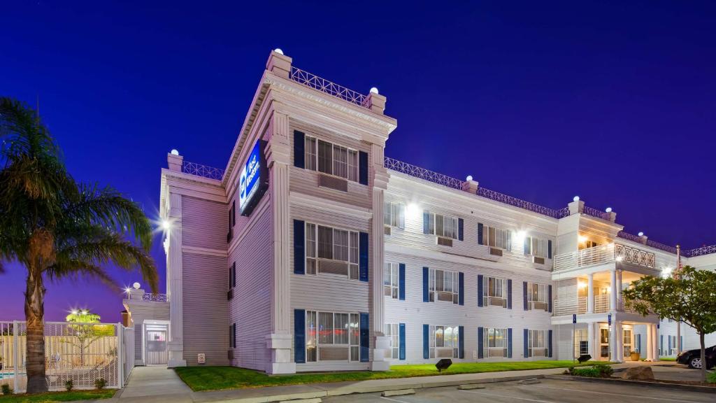 a large white building with a clock on it at Best Western Salinas Monterey in Salinas
