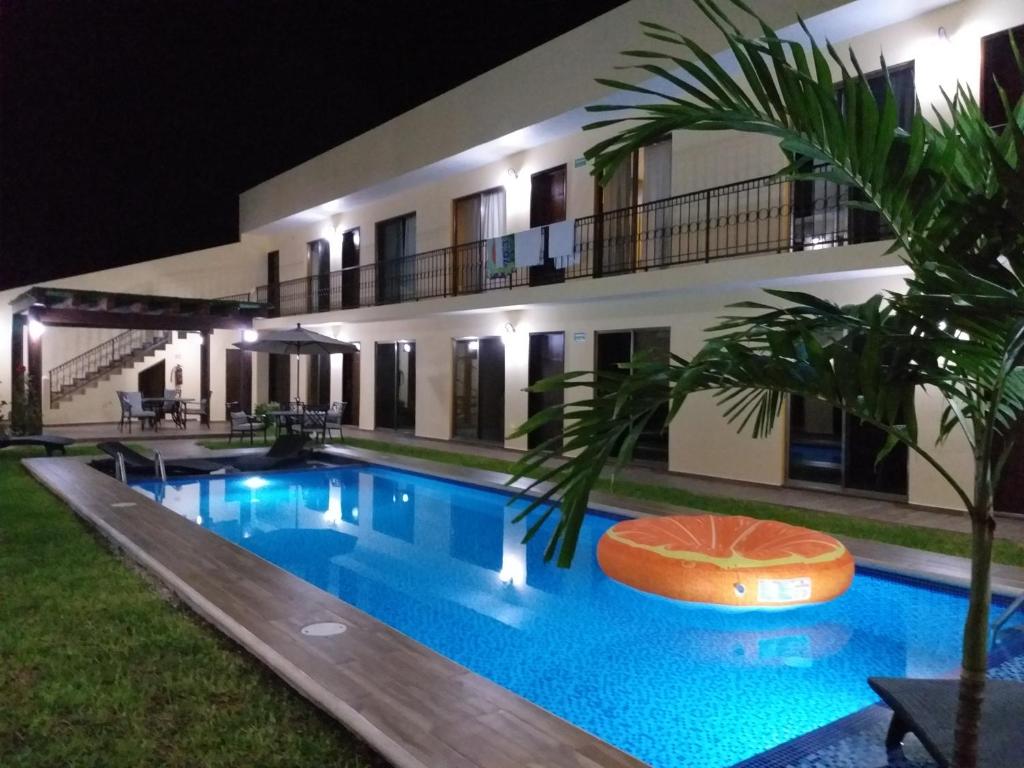 a villa with a swimming pool at night at PRIME VILLAGE Cozumel in Cozumel