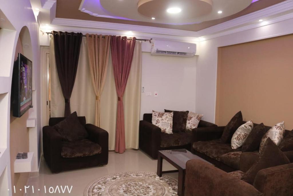 a living room with a couch and two chairs at Amir flat -ميامي- عائلات فقط in Alexandria