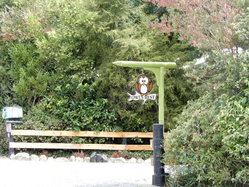 a sign for a zoo with a monkey on it at Owls' Rest in Linkwater