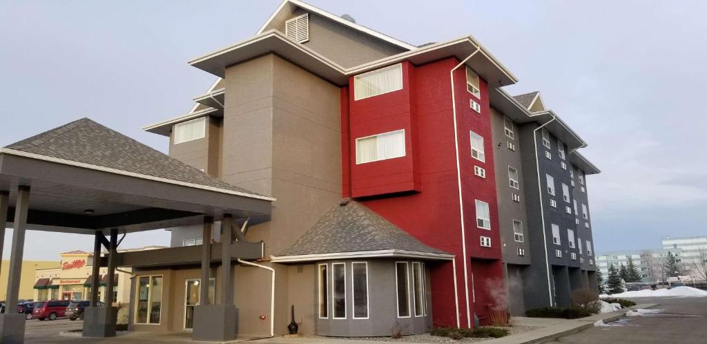 a red building on the side of a building at SureStay Plus Hotel by Best Western Lethbridge in Lethbridge