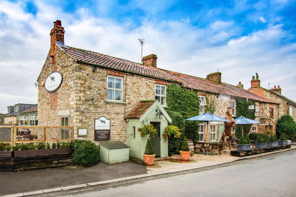 a building with a clock on the side of it at Black Horse Inn in Northallerton