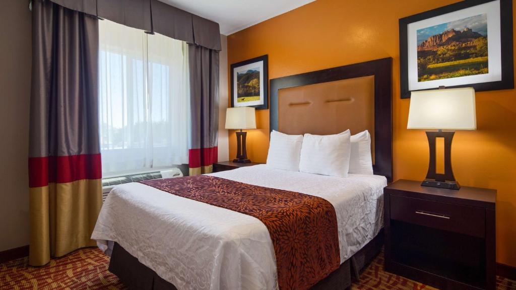 a hotel room with a bed and a window at Best Western Plus Zion West in La Verkin