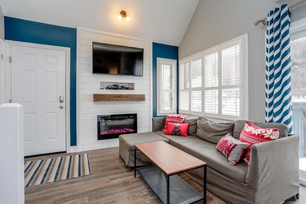 a living room with a couch and a fireplace at Blue Mountain Studio Loft at North Creek Resort in Blue Mountains
